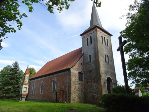 Widok kościoła z boku z wieżą i krzyżem